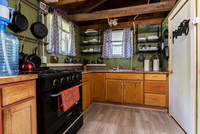 2198 Eight Rod Rd, Sidney, ME 04330 - kitchen with black gas stove, healthy amount of natural light, light wood finished floors, brown cabinetry, and wood ceiling