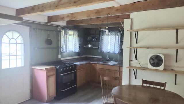 2198 Eight Rod Rd, Sidney, ME 04330 - kitchen featuring black gas stove, plenty of natural light, wood finished floors, brown cabinets, and beamed ceiling
