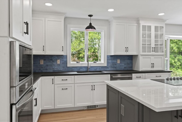 35 Rice Rd, Boothbay, ME 04544 - kitchen with appliances with stainless steel finishes, white cabinetry, decorative light fixtures, tasteful backsplash, and recessed lighting