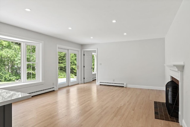 35 Rice Rd, Boothbay, ME 04544 - unfurnished living room featuring baseboard heating, light wood finished floors, recessed lighting, and a fireplace with flush hearth