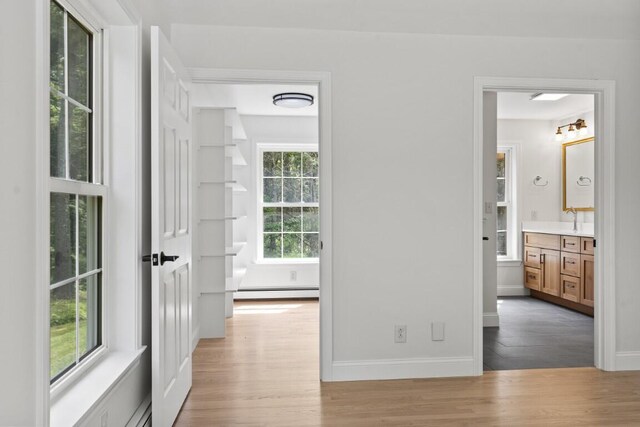 35 Rice Rd, Boothbay, ME 04544 - hallway featuring a baseboard heating unit and wood finished floors