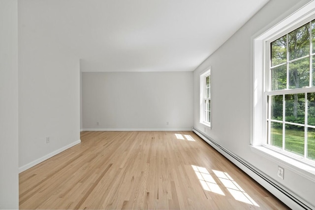 35 Rice Rd, Boothbay, ME 04544 - spare room with a baseboard heating unit, healthy amount of natural light, and light wood-style floors