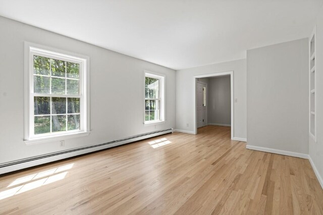 35 Rice Rd, Boothbay, ME 04544 - empty room featuring plenty of natural light, a baseboard heating unit, and light wood-type flooring