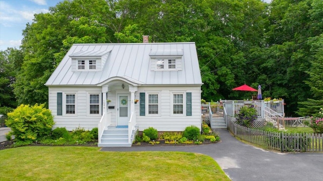 278 S Main St, Auburn, ME 04210 - view of front of home with a standing seam roof, a chimney, a metal roof, and a deck