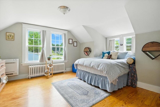 278 S Main St, Auburn, ME 04210 - bedroom with radiator, lofted ceiling, light wood-type flooring, and multiple windows
