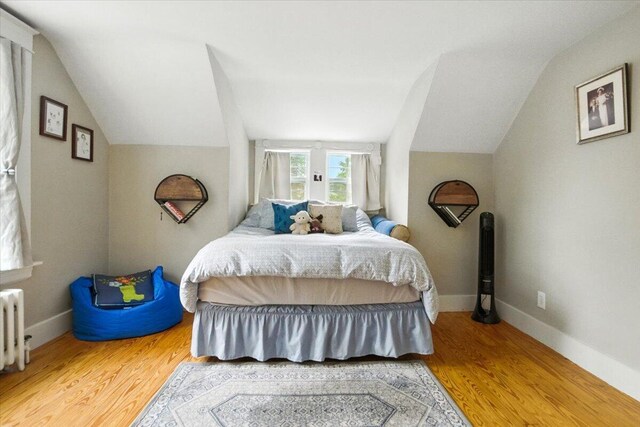 278 S Main St, Auburn, ME 04210 - bedroom featuring vaulted ceiling, wood finished floors, and radiator heating unit