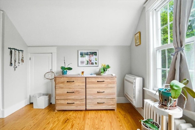 278 S Main St, Auburn, ME 04210 - sitting room with vaulted ceiling, radiator heating unit, plenty of natural light, and light wood-type flooring