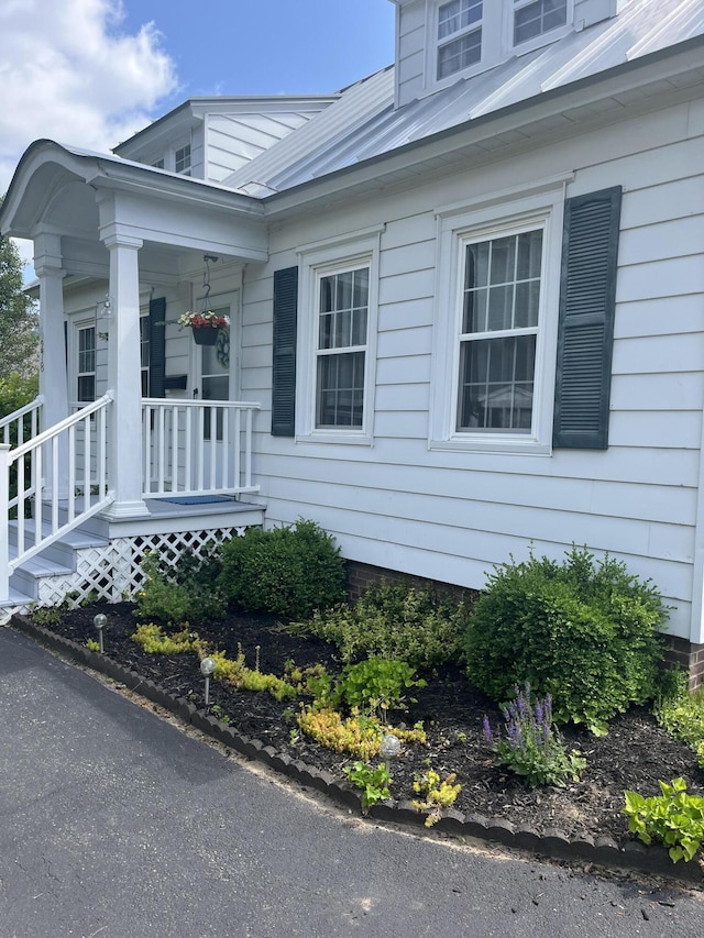 278 S Main St, Auburn, ME 04210 - view of side of home featuring a porch and a metal roof