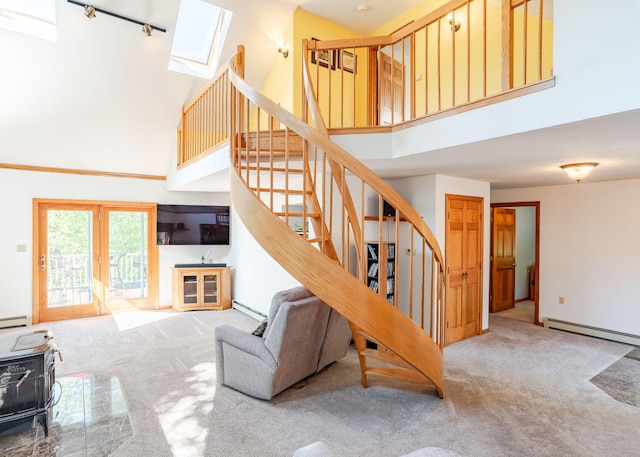 103 Hardscrabble Rd, Hollis, ME 04042 - stairway featuring carpet floors, a towering ceiling, baseboard heating, a baseboard heating unit, and a skylight