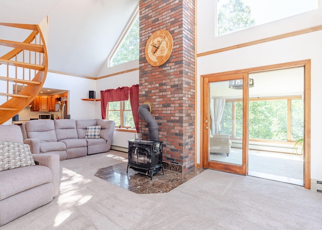 103 Hardscrabble Rd, Hollis, ME 04042 - carpeted living room featuring high vaulted ceiling, a wood stove, and a baseboard radiator