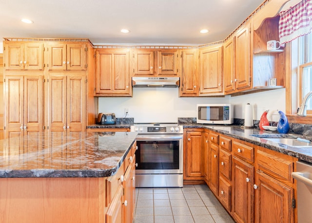 103 Hardscrabble Rd, Hollis, ME 04042 - kitchen with stainless steel appliances, recessed lighting, under cabinet range hood, light tile patterned flooring, and dark stone countertops