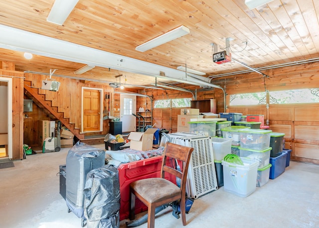 103 Hardscrabble Rd, Hollis, ME 04042 - garage featuring a garage door opener, wooden walls, and wood ceiling