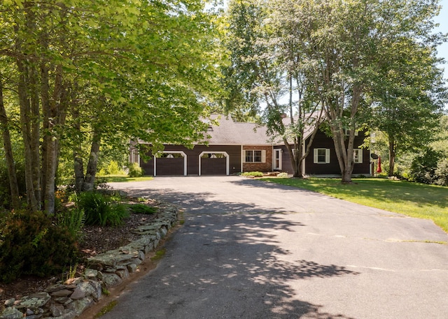 103 Hardscrabble Rd, Hollis, ME 04042 - view of front of property featuring asphalt driveway, a front lawn, an attached garage, and a chimney
