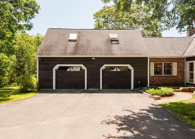 103 Hardscrabble Rd, Hollis, ME 04042 - view of front of home featuring asphalt driveway, brick siding, roof with shingles, a chimney, and an attached garage