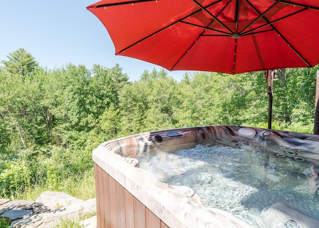 103 Hardscrabble Rd, Hollis, ME 04042 - view of patio / terrace with a hot tub and a view of trees