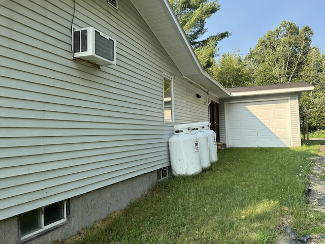 157 Cyr Rd, Cross Lake Twp, ME 04779 - view of side of home with a garage, a wall mounted AC, and a lawn