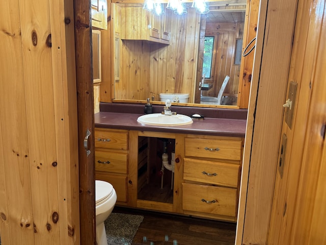 157 Cyr Rd, Cross Lake Twp, ME 04779 - half bathroom with vanity, wood walls, and wood finished floors