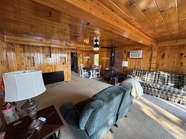 157 Cyr Rd, Cross Lake Twp, ME 04779 - living area featuring a wood stove, carpet floors, wood walls, wood ceiling, and a wall mounted air conditioner