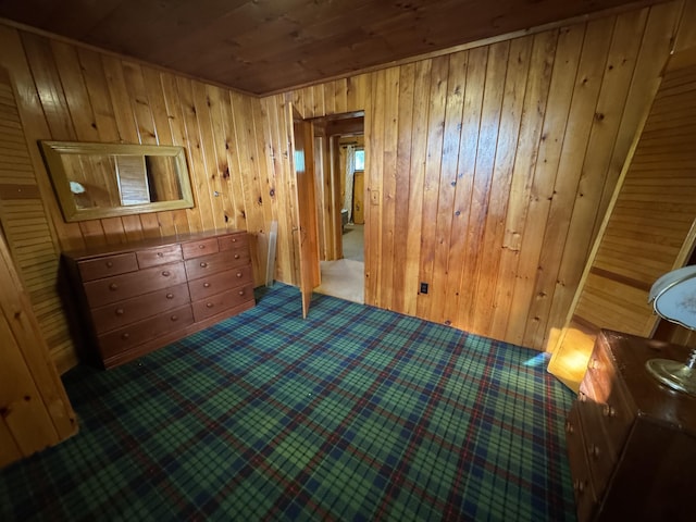 157 Cyr Rd, Cross Lake Twp, ME 04779 - unfurnished bedroom featuring wood ceiling, carpet, and wooden walls