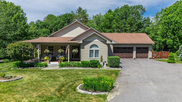 250 Mere Point Rd, Brunswick, ME 04011 - view of front of house with a porch, asphalt driveway, and an attached garage
