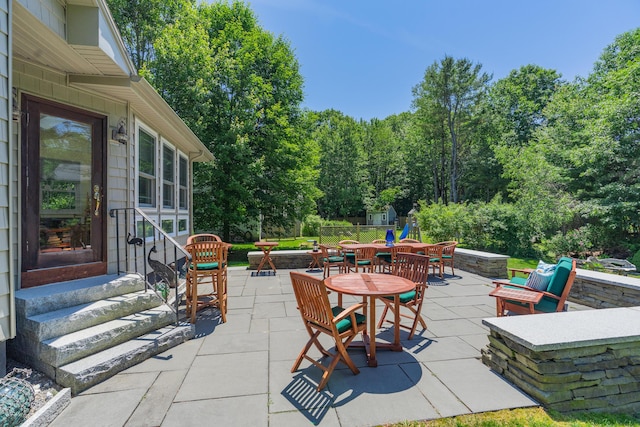 250 Mere Point Rd, Brunswick, ME 04011 - view of patio / terrace with entry steps, outdoor dining area, and a fire pit