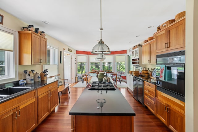 250 Mere Point Rd, Brunswick, ME 04011 - kitchen with oven, stainless steel gas stovetop, dark countertops, dark wood-style flooring, and a kitchen island