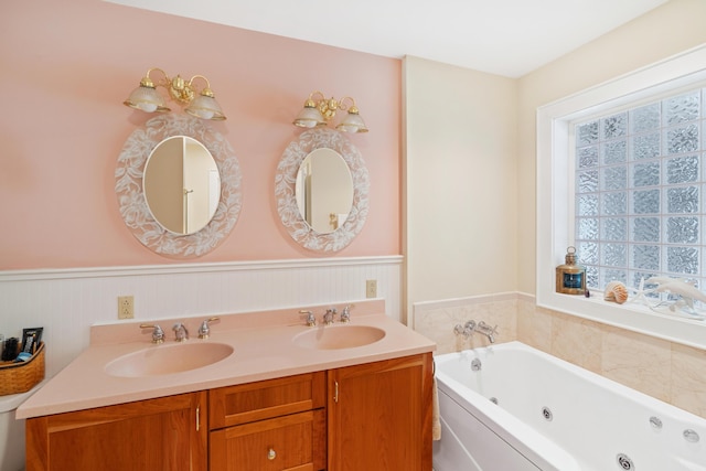 250 Mere Point Rd, Brunswick, ME 04011 - bathroom with plenty of natural light, wainscoting, a jetted tub, and double vanity