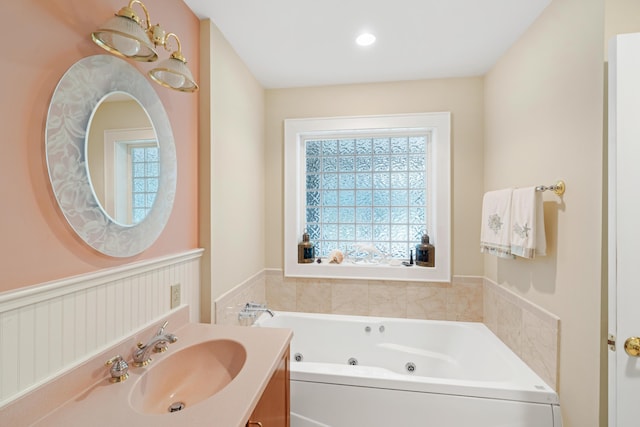 250 Mere Point Rd, Brunswick, ME 04011 - bathroom with a whirlpool tub, vanity, and a wainscoted wall