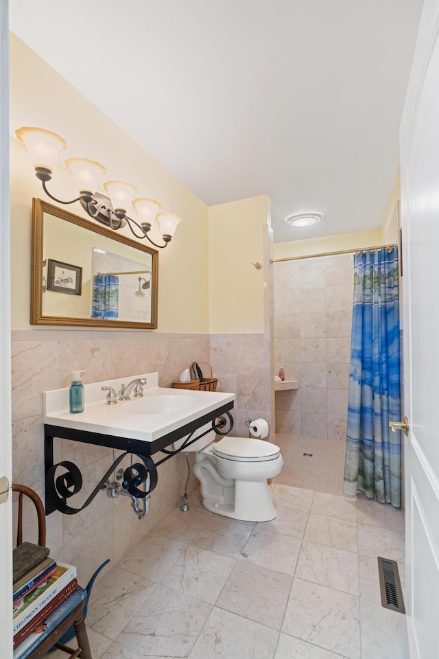 250 Mere Point Rd, Brunswick, ME 04011 - bathroom with tile walls, a tile shower, a wainscoted wall, and marble finish flooring