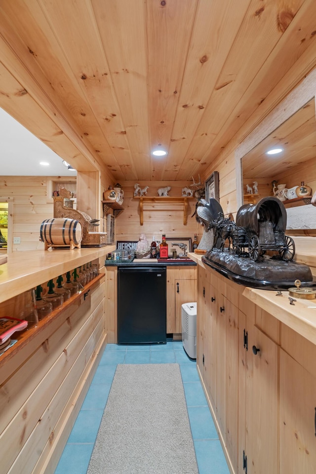 250 Mere Point Rd, Brunswick, ME 04011 - kitchen featuring wooden walls, light brown cabinets, refrigerator, light tile patterned flooring, and wood ceiling