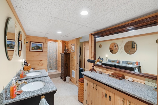 250 Mere Point Rd, Brunswick, ME 04011 - full bathroom with a shower with shower curtain, double vanity, a paneled ceiling, wooden walls, and recessed lighting