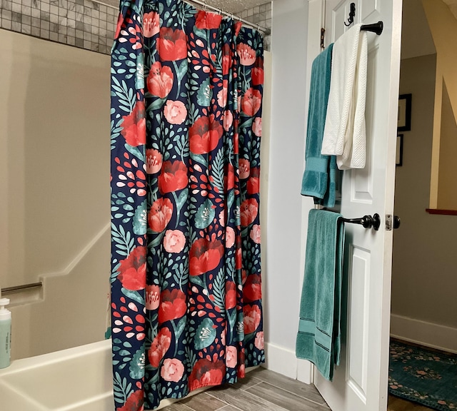 10 Aegis Dr Unit B, Bath, ME 04530 - bathroom with wood finished floors and shower / bath combo with shower curtain