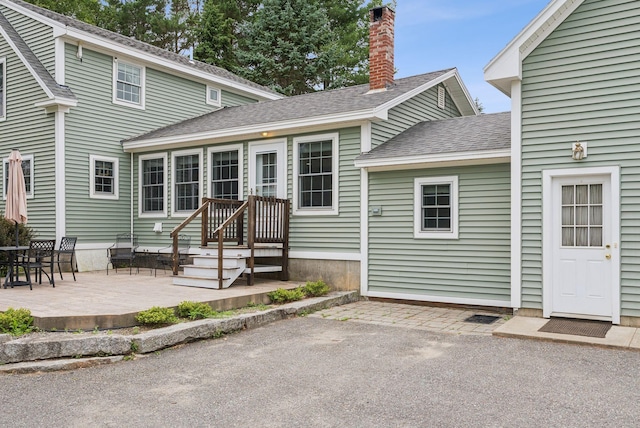 3729 Union St, Levant, ME 04456 - rear view of property featuring a patio area, a shingled roof, and a chimney