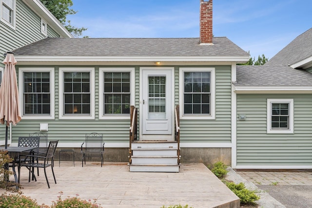 3729 Union St, Levant, ME 04456 - rear view of house with a shingled roof, entry steps, a chimney, and a patio