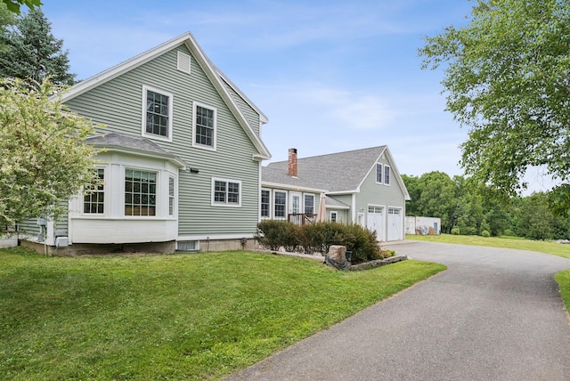 3729 Union St, Levant, ME 04456 - view of front of property featuring an attached garage, asphalt driveway, and a front yard