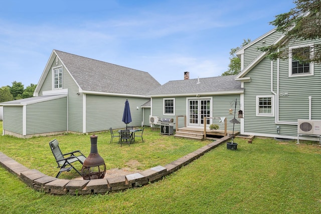 3729 Union St, Levant, ME 04456 - back of house featuring an outdoor fire pit, a chimney, a yard, roof with shingles, and french doors