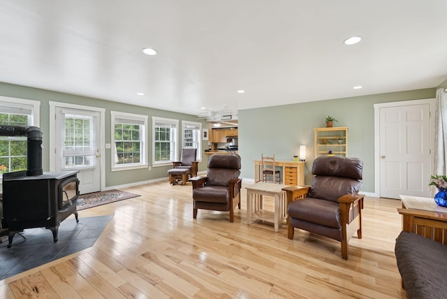 3729 Union St, Levant, ME 04456 - living area featuring light wood finished floors, recessed lighting, and a wood stove