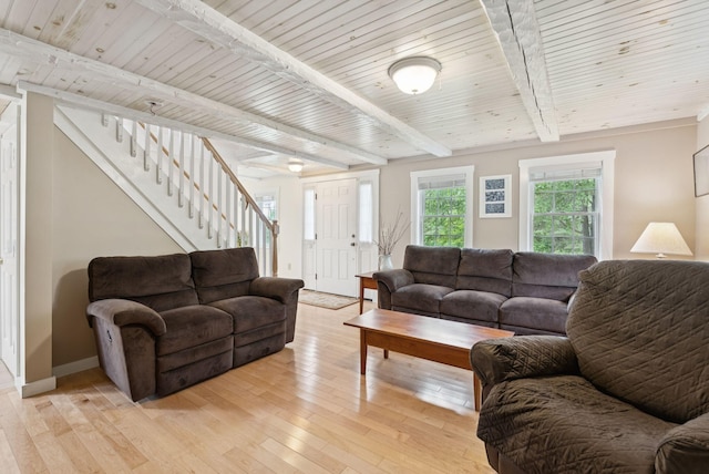 3729 Union St, Levant, ME 04456 - living room featuring stairway, light wood-style flooring, and a wooden ceiling with exposed beams