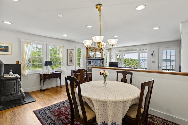 28 Will Alley Rd, South Bristol, ME 04568 - dining room with a chandelier, a wood stove, hardwood / wood-style floors, and recessed lighting