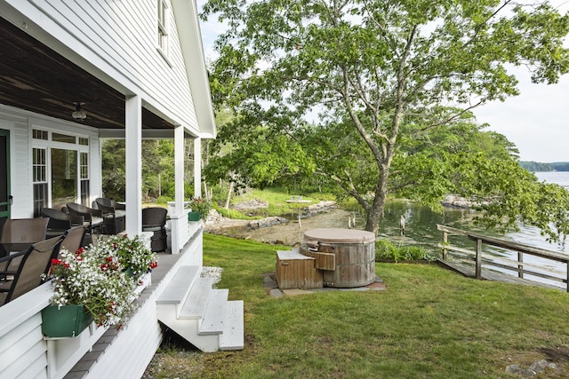 28 Will Alley Rd, South Bristol, ME 04568 - view of grassy yard featuring a water view, a ceiling fan, and a hot tub