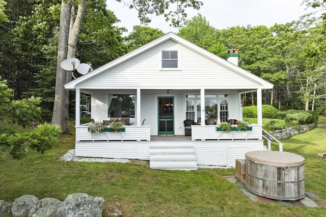 28 Will Alley Rd, South Bristol, ME 04568 - rear view of house with a hot tub, a chimney, a yard, and a porch