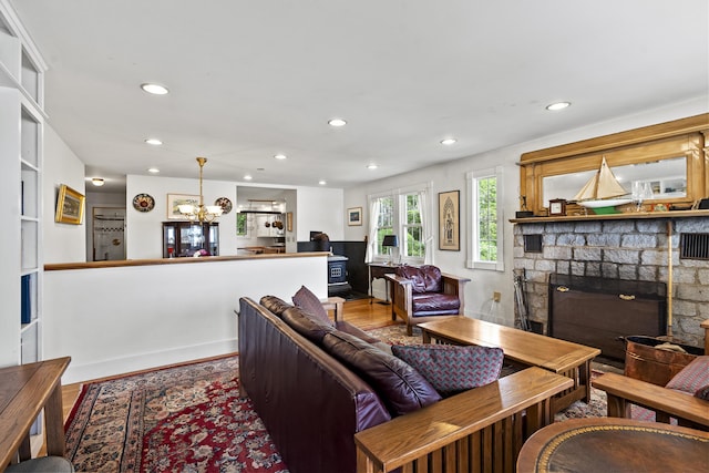 28 Will Alley Rd, South Bristol, ME 04568 - living room with wood finished floors, a fireplace, recessed lighting, and a chandelier
