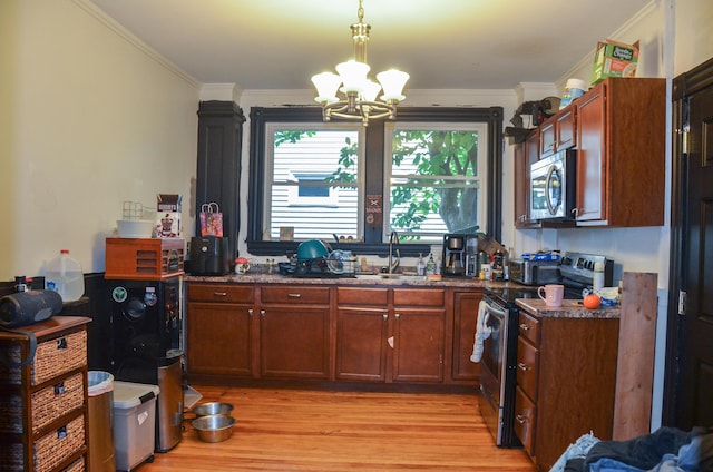 40 Chapel St, Augusta, ME 04330 - kitchen featuring appliances with stainless steel finishes, a chandelier, light wood finished floors, crown molding, and decorative light fixtures