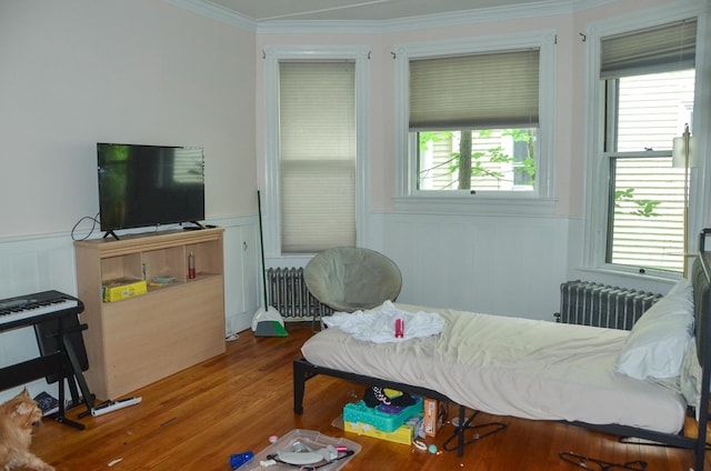 40 Chapel St, Augusta, ME 04330 - living area featuring radiator, crown molding, a wainscoted wall, wood finished floors, and a decorative wall