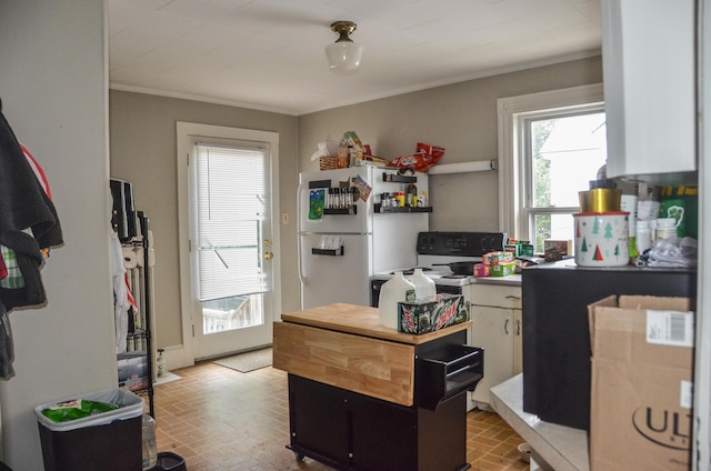 40 Chapel St, Augusta, ME 04330 - kitchen featuring brick patterned floors, white appliances, and crown molding