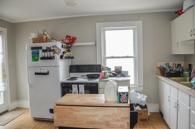40 Chapel St, Augusta, ME 04330 - kitchen featuring freestanding refrigerator, electric range, brick patterned flooring, healthy amount of natural light, and crown molding