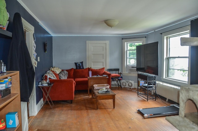 40 Chapel St, Augusta, ME 04330 - living area with radiator heating unit, wood finished floors, and cooling unit