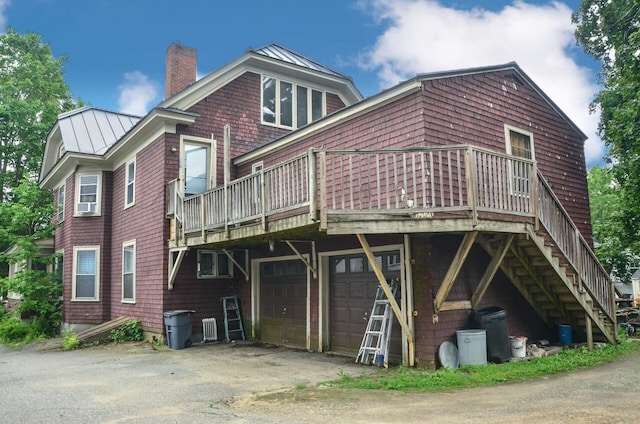 40 Chapel St, Augusta, ME 04330 - back of house featuring a standing seam roof, a chimney, a garage, and a deck