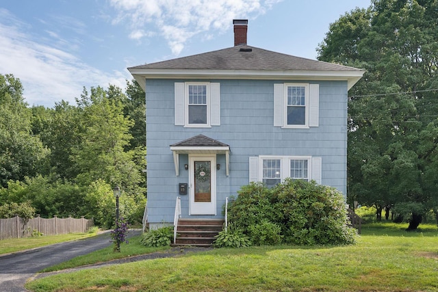 15 Huston Ave, Auburn, ME 04210 - view of front of house featuring a chimney and a shingled roof