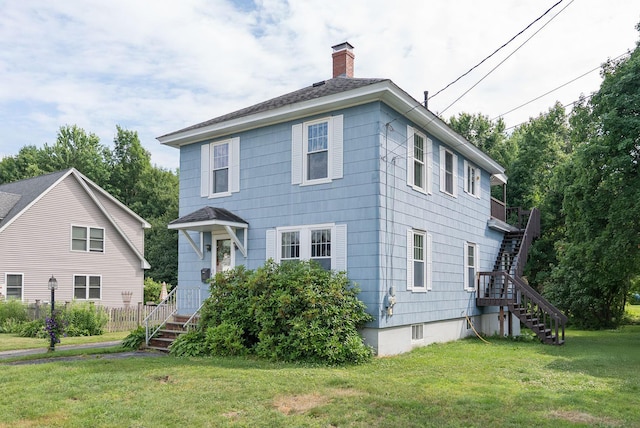 15 Huston Ave, Auburn, ME 04210 - view of front of home with stairway, a chimney, and a front yard